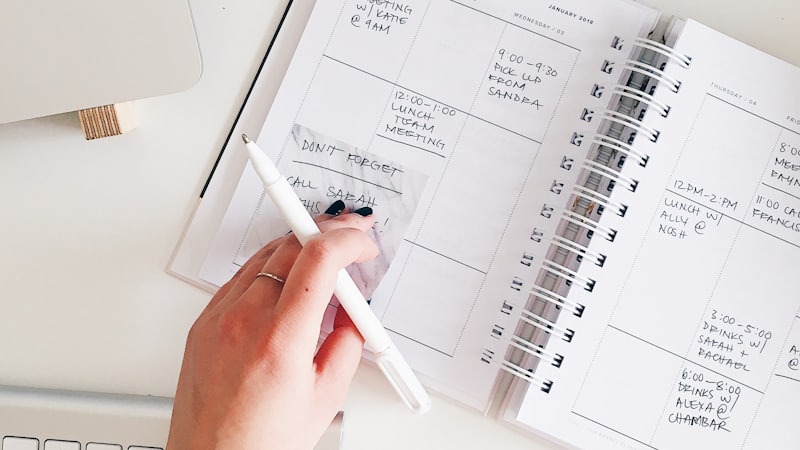 A budget planner notebook and pen, illustrating the 50/30/20 budgeting rule