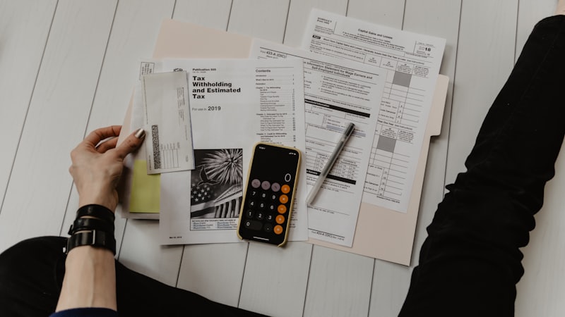 Calculator and tax documents for comparing the old and new income tax regime