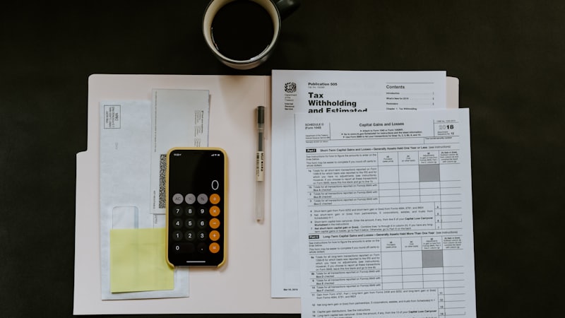 Tax documents and a calculator used for Section 80C tax-saving planning