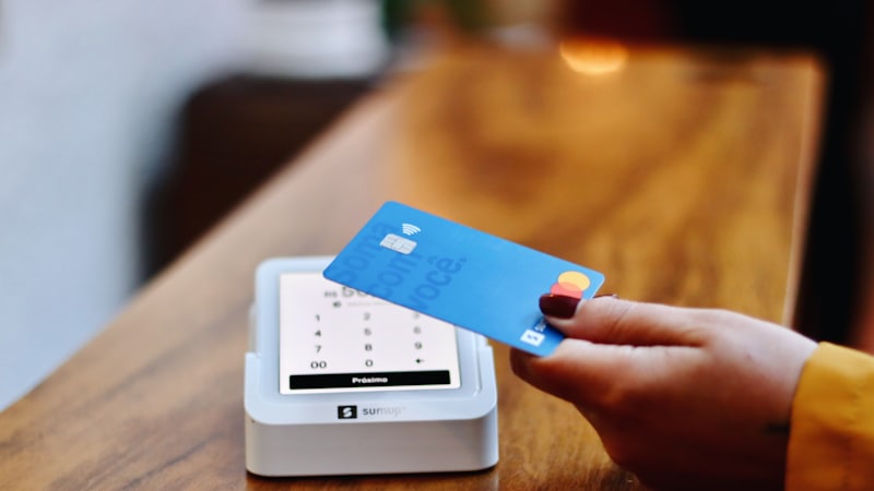 Paying with a credit card at a payment terminal, illustrating credit card interest
